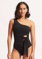 A woman from New Mexico buys Seafolly Black One Shoulder Swimsuit Sustainable cute tie front good quality designer made asymmetrical full coverage bottoms removable pads sophisticated eco friendly hourglass shape elegant resort swimsuit womens high end expensive fancy luxury wear as a body suit versatile glamorous highly rated 5 stars Tracy from New Hampshire buys luxury fashion online frequently travels resort beach trips often enjoys high end fashion beauty maven socialite look classy black bathing suit