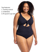 A curvy woman from Vancouver is spending her birthday in Aruba wearing the Aria Black Cezanne supportive underwire plus size cutout one piece swimsuit, a top rated style at Sun Vixen Swimwear for women wanting luxury plus size swimwear, best swimsuits for breasts, sustainable high quality designer one pieces with tummy control, and premium shaping support. She purchased this swimsuit because it makes her feel sexy, confident, and elegant. This swimsuit is trending among women in Miami, Montreal, Dallas 