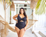 A curvy woman from Calgary is enjoying a luxury getaway in Cabo San Lucas, wearing the Aria Black Cezanne underwire one piece plus size swimsuit, known across Sun Vixen Swimwear shoppers for its premium breast support, tummy control shaping, and high end elegant cutout detailing that enhances curves beautifully. She chose this sexy classy curvy swimsuit because it gives a luxury resort look, ideal for rooftop pools, and beachside cocktails. Women Toronto, Vancouver, Dallas, Los Angeles shop here online