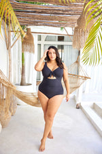 curvy traveler from New York City is enjoying a luxury winter escape in St. Barts, wearing the Aria Black Cezanne tummy control plus size underwire swimsuit, chosen for its premium shaping, luxury underwire lift, best support for sagging breasts, and sophisticated designer cutout design. She loves how this swimsuit enhances her waist and bust, giving her a sleek upscale resort look. Women from Montreal, Vancouver, Houston, and Los Angeles search Sun Vixen Swimwear for best quality plus size bathing suits