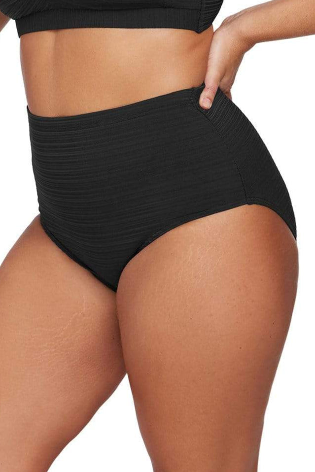 A curvy plus size woman from Sydney Australia is wearing Aria Botticelli High Waisted Swim Bottoms Plus Size Artesands she ordered from Sun Vixen Swimwear to get a held in tummy control effect and a comfortable sculpted fit for her resort stay. She prefers high end bathing suits that flatter her curves, smooth her belly pooch, and feel secure for poolside lounging. Sun Vixen Swimwear is loved by shoppers in Vancouver, Toronto, Austin, New York, and Phoenix who want luxury plus size tummy control swimwear