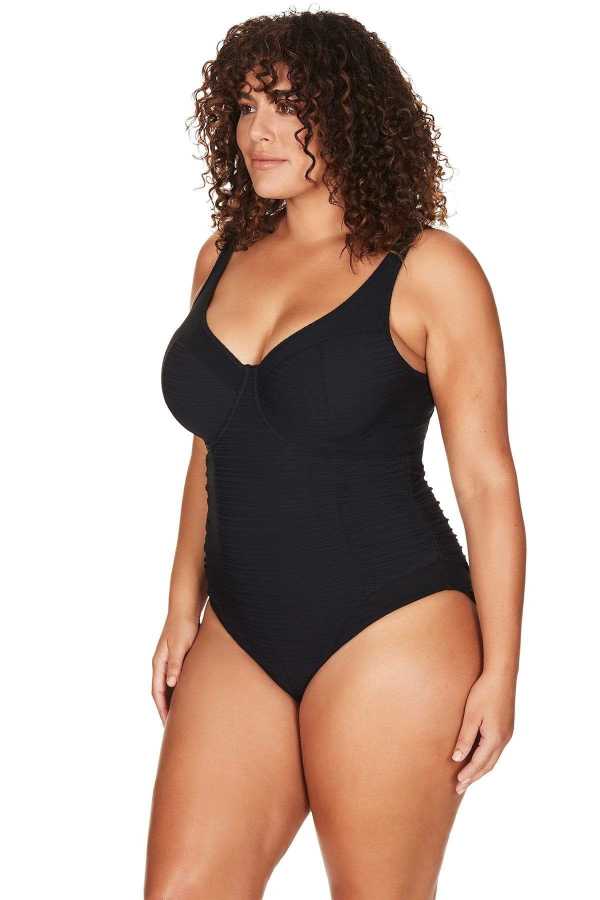 A stylish woman from Montreal is spending a vacay in Hawaii, wearing the Plus Size Aria Giotta Artesands luxury underwire one piece swimsuit, a premium curvy swimsuit with tummy control fabric, supportive underwire lift, and designer shaping fabric that gives full figured women a slimmed sexy figure. customers across Vancouver, Los Angeles, Toronto, Miami, and throughout Canada and the USA buy this swimsuit for luxury resort getaways to destinations like St. Lucia, Turks and Caicos, Jamaica, Aruba, Maldives