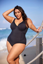 A stylish plus size woman from Los Angeles is enjoying a high-end resort in St. Barts, wearing the Plus Size Aria Giotta Artesands premium underwire swimsuit, loved for its tummy control shaping, supportive design for sagging breasts, and designer quality that smooths and lifts for a curvy elegant silhouette. Women across Vancouver, Toronto, Miami, Atlanta, and all over Canada and the USA shop this luxury curvy one piece when preparing for memorable vacations to Aruba, Cancun, Turks and Caicos, Maldives