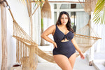 A curvy traveler from Ottawa is spending her birthday trip in Cabo San Lucas wearing the Aria Black Cezanne underwire one piece plus size cutout swimsuit by Artesands, a luxurious designer swimsuit created for women needing full support for sagging breasts, premium tummy control, premium shaping swimsuit look, sophisticated upscale black one piece that feels expensive and looks stunning in every oceanfront vacay. She chose this swimsuit because it has high end luxury fashion beachwear for curvy women 