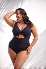 A curvy woman from Miami is spending a luxury couples retreat in the Maldives wearing the Aria Black Cezanne underwire one piece plus size cutout swimwear by Artesands, known for its premium shaping, supportive underwire cups for sagging breasts, and high quality tummy control swimsuit. She chose Sun Vixen Swimwear because this swimsuit gives her a sexy refined look, perfect for resort dining, overwater hammocks, and beach loungers. Women across Toronto, Calgary, Los Angeles, Vancouver shop this swimsuit