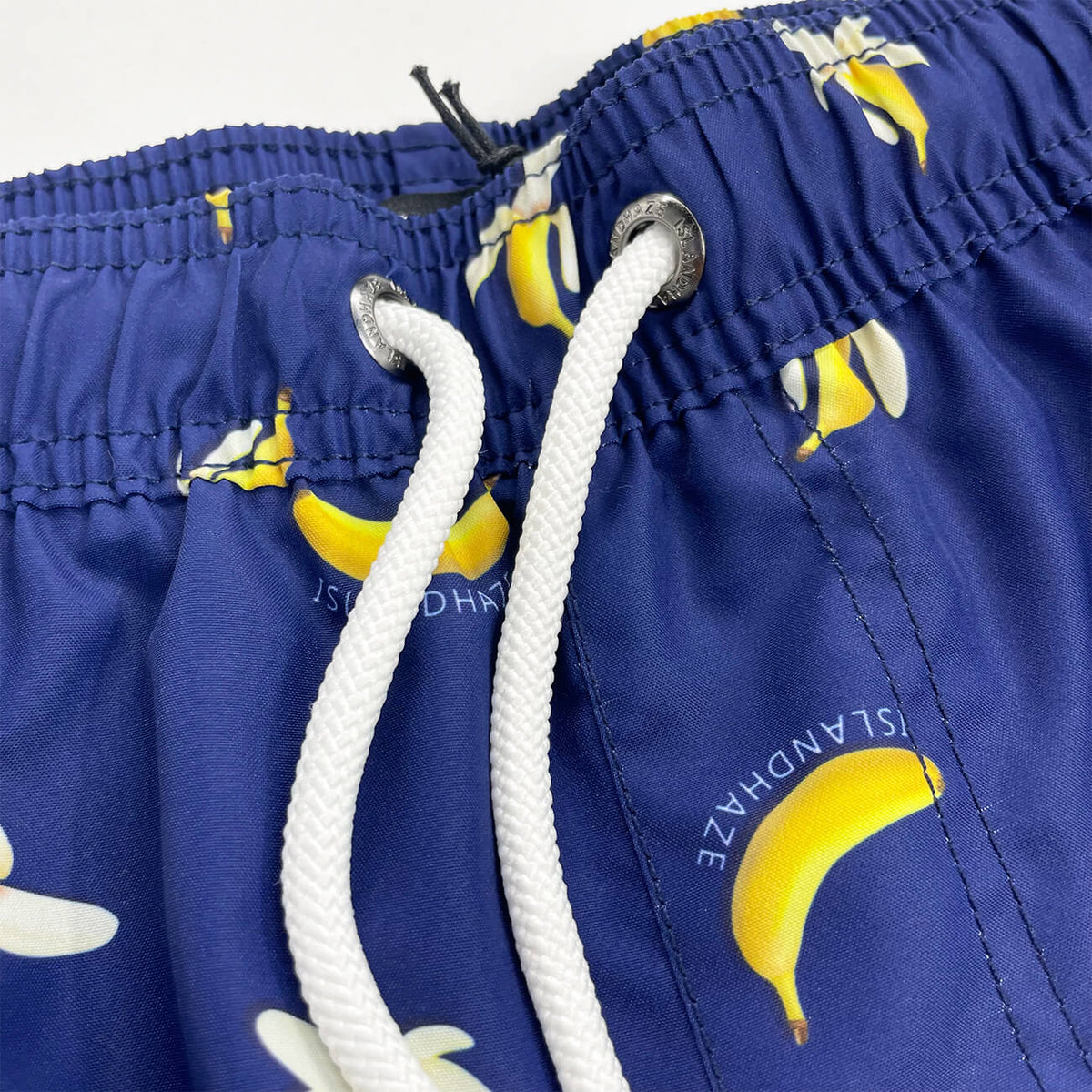 Banana Swim Trunks Island Haze Tropical print Mens Shorts cool print funny shorts navy blue 5 inch inseam elastic waist drawstring front inner mesh lining side pockets back velcro close pocket quick dry soft fabric unique lucky banana swim short lively print vacation beach vibe vacation hilarious couples trip joke ridiculous guys blue navy unusual popular best mens swim good price ships fast buy canada usa life of the party goofy travel online shopping enthusiast beauty maven gym goer travels often joker  