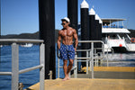 Banana Swim Trunks Island Haze Tropical print Mens Shorts cool print funny shorts navy blue 5 inch inseam elastic waist drawstring front inner mesh lining side pockets back velcro close pocket quick dry soft fabric unique lucky banana swim short lively print vacation beach vibe vacation hilarious couples trip joke ridiculous guys blue navy unusual popular best mens swim good price ships fast buy canada usa calgary omaha nebraska SC  travel online shopping enthusiast beauty maven gym goer travels often sexy 