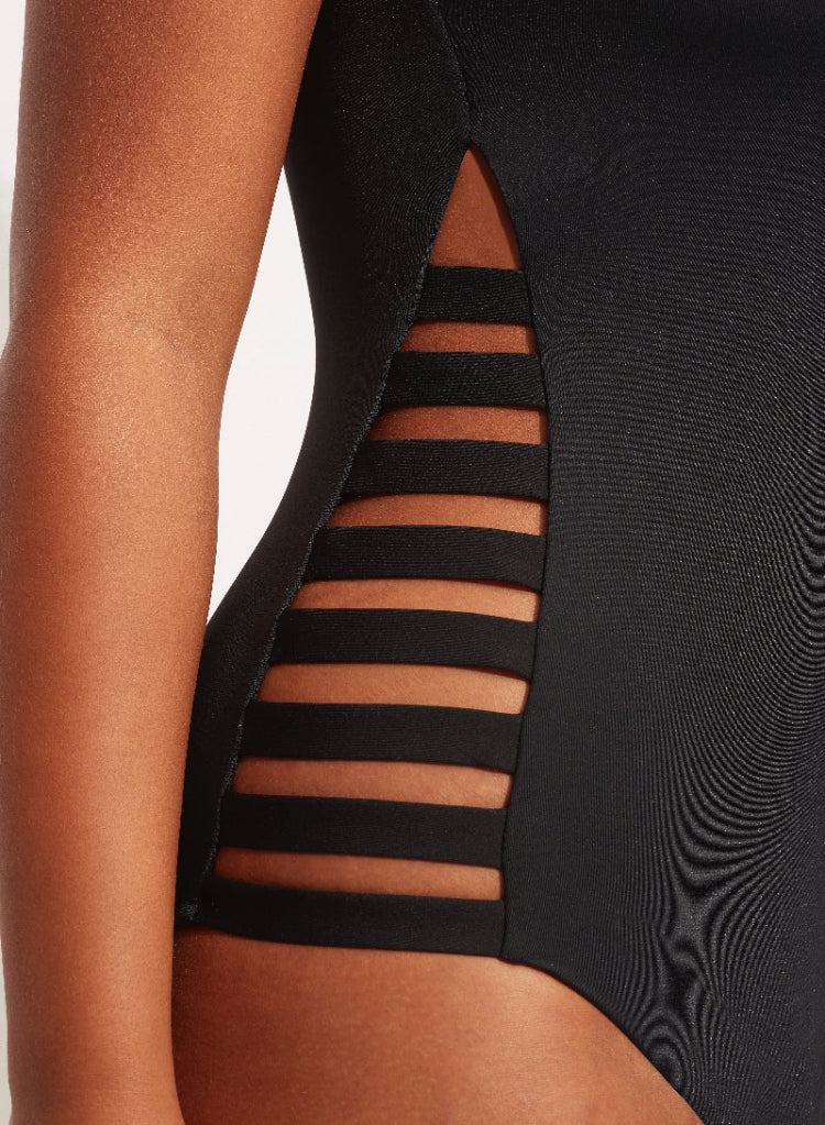 Black high neck one piece swimsuit sustainable seafolly edgy cutout sides sexy rocker glamorous sophisticated unique fancy covers upper chest for sensitive skin minimizes sun exposure full coverage bottoms zip back high quality luxury fabric designer made long zipper pull easy on/off outdoor swimsuit water cute pretty elegant unusual Donna rated 5/5 eco friendly fabric beach traveller resort beauty maven frequently buys online fashionista shopping enthusiast recently purchased luxury beach fashion for trip 