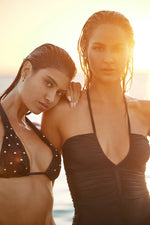 A fashion enthusiast from Atlanta wearing PQ Swim Gold Beaded Macrame Bikini Top midnight beaded brynn halter Midnight Basic Ruched Bottoms she purchased online boutique sun vixen swimwear that luxury shoppers use to buy womens swimwear, sophisticated swimsuits for luxury vacations, hottest bikinis for resort holidays, high fashion bathing suits, best quality fashionable swimwear, glamorous black bikinis, exquisite embellished sexy bikinis, sexiest luxe bathing suits with fast shipping USA Canada worldwide