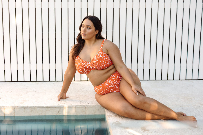 Plus size woman in Vancouver wearing Copper Monet soft cup underwire cheetah print bikini set on her luxury resort vacation to cancun mexico. Artesands high waist tummy control bikini bottoms supportive bikini top give toned slim glamorous vacation look for her pool days. She ordered it from sun vixen swimwear for sophisticated curvy swimsuits that give her that sexy tummy control look. no.1 store for designer plus size swimwear, stylish tummy control bikinis, sexy animal print swimsuits boutique website