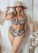 A curvy woman from San Jose California is on her Maldives getaway wearing Artesands saphare chagall leopard bikini bottoms paired with a underwire animal print leopard bikini top. She chose these mid rise tummy control compression bikini bottoms and supportive swimsuit top for the way they cinch her waist so she looks slimmed and toned. She bought them from Sun Vixen Swimwear a luxury womens swimwear boutique online known across Canada and USA for best plus size bikinis, flattering good quality bathing suit
