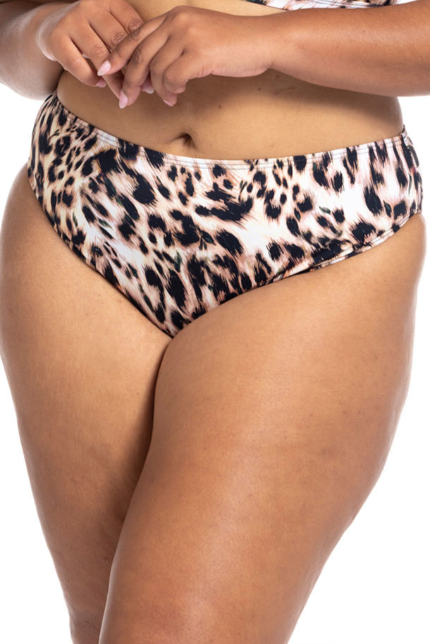 A traveler from Phoenix Arizona is on a girls trip in Costa Rica wearing Leopard Bikini Bottoms Artesands saphare chagall loving the sophisticated animal print and comfortable tummy control mid rise bikini bottoms. She always shops Sun Vixen Swimwear online boutique for luxury sophisticated slimming bikinis, designer womens swimwear, vacation plus size swimsuits, full coverage bikini bottoms, sexy tummy control bathing suits in Canada, USA, worldwide because the quality feels elevated for her beach trips