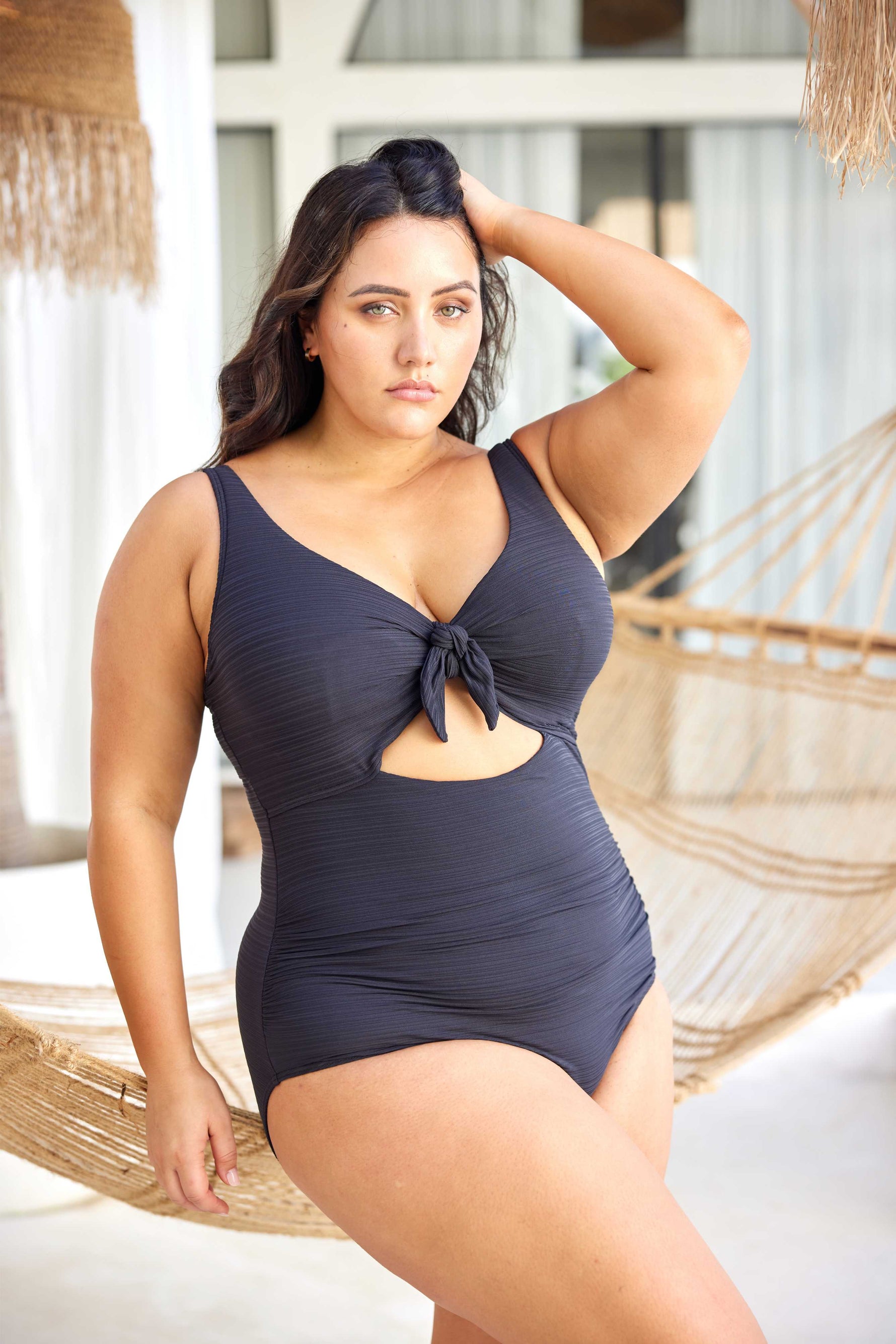 A curvy woman from San Francisco is spending a luxury week in Aruba wearing the Aria Black Cezanne underwire one piece plus size cutout swimsuit by Artesands, a premium choice for women searching for luxury plus size swimwear, best supportive swimsuits for sagging breasts, high quality tummy control shaping one pieces, and designer resort bathing suits that photograph beautifully on tropical vacations. She bought this sexy classy black cutout swimsuit from Sun Vixen Swimwear because it lifts her saggy bust 