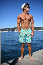 Pineapple Swim Trunks Island Haze cool print funny shorts pineapples 5 inch inseam elastic waist drawstring front inner mesh lining side pockets back velcro close pocket quick dry soft fabric unique swingers swim shorts lucky pineapple print tropical vibe vacation hilarious couples trip joke ridiculous guys blue aqua light blue unusual popular best mens swim good price ships fast buy canada usa montreal cancun travel online shopping enthusiast beauty maven gym goer travels often beach vacations group travel