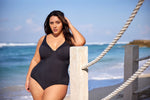 A curvy woman from Edmonton is enjoying a tropical getaway in Aruba, wearing the Plus Size Aria Giotta Artesands luxury underwire one piece swimsuit, a premium swimsuit with tummy control, supportive bust, elegant designer swimsuit look perfect for upscale beach destinations. This shaping one piece swimsuit smooths her waist, lifts her bust, and gives her a polished high end resort look. Women across Toronto, Vancouver, Chicago choose this swimsuit for tropical trips to Miami, Hawaii, Maldives, Mallorca