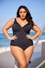 A curvy woman from Vancouver is celebrating her dream vacation in Mauritius, wearing the Plus Size Aria Giotta Artesands luxury underwire one piece swimsuit, chosen for its premium tummy control, shape contouring high quality bust support that gives full figured women a polished luxury resort look. She strolls along Belle Mare Beach feeling confident in the swimsuit’s elegant high end silhouette. Sun Vixen Swimwear have luxury customers from Toronto, Dallas, Houston, Montreal, San Diego, and Canada USA 