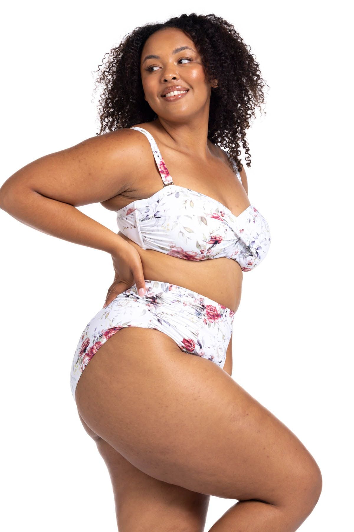 A plus size woman from Seattle USA is getting ready for her girls getaway to Barbados, wearing the Clementine White Botticelli High Waisted Bikini Bottoms Artesands for a slimmed, smooth figure. Ruched tummy control bikini bottoms makes her feel sophisticated. She ordered this from Sun Vixen Swimwear, boutique website known for carrying the most flattering plus size bikinis online for curvy women who want elegant, fashionable pieces. Shoppers from Halifax, Chicago, and San Diego love shop frequently online 