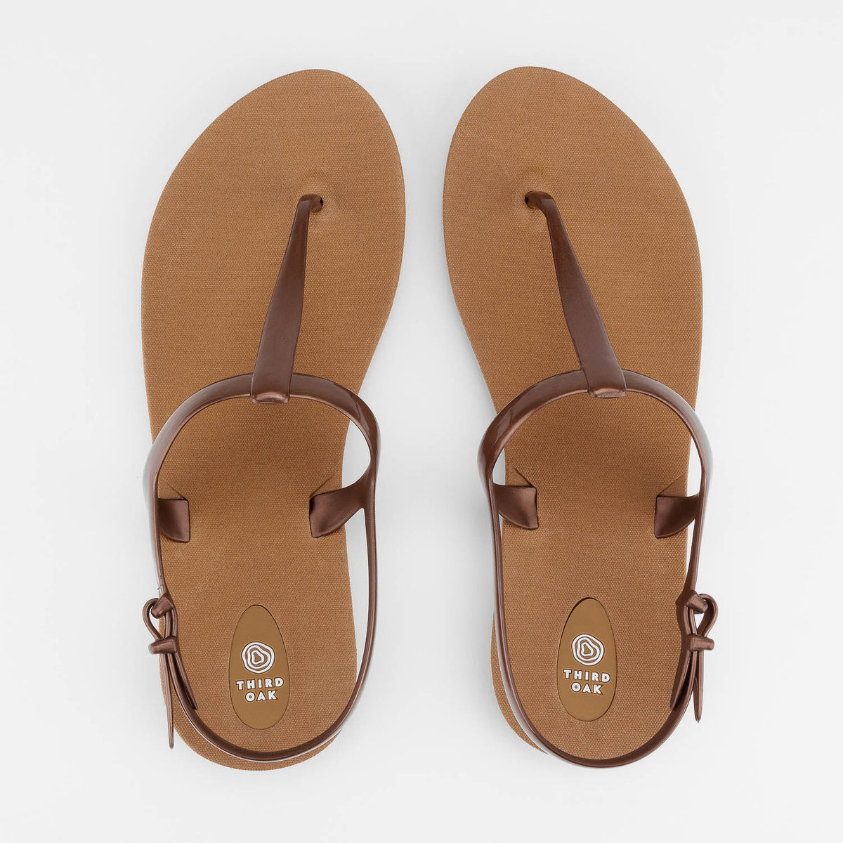 Sandals Journey designed by Third Oak metallic finish vegan cruelty free sturdy design made with bio based material 45% soy by weight 100% recyclable made in the USA eco friendly flats flip flops stylish shiny cute adjustable heel strap vacation good quality american made eco safe environmentally friendly best flats vacation open toe thongs good quality buy online clearance sale neutral color copper bronze brown beach shoes dressy cute pretty elegant goes with shorts dress up or down good carry on stylish 