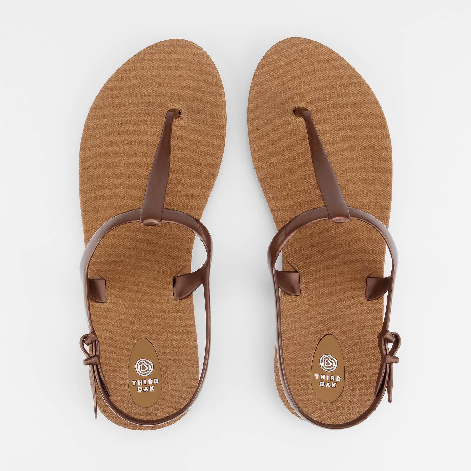 Sandals Journey designed by Third Oak metallic finish vegan cruelty free sturdy design made with bio based material 45% soy by weight 100% recyclable made in the USA eco friendly flats flip flops stylish shiny cute adjustable heel strap vacation good quality american made eco safe environmentally friendly best flats vacation open toe thongs good quality buy online clearance sale neutral color copper bronze brown beach shoes dressy cute pretty elegant goes with shorts dress up or down good carry on stylish 