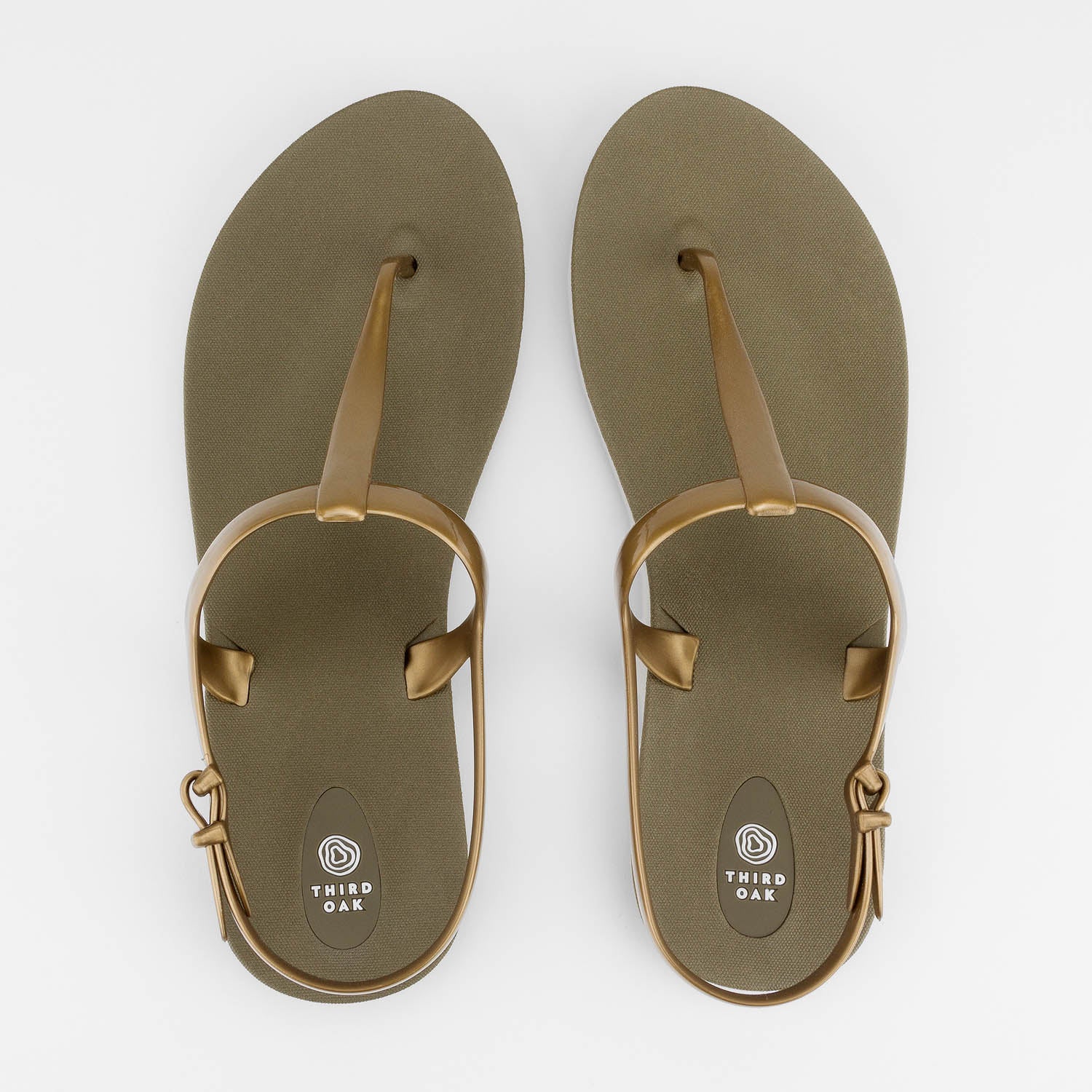 Sandals Journey designed by Third Oak metallic finish vegan cruelty free sturdy design made with bio based material 45% soy by weight 100% recyclable made in the USA eco friendly flats flip flops stylish shiny cute adjustable heel strap vacation good quality american made eco safe environmentally friendly best flats vacation open toe thongs good quality buy online clearance sale neutral color gold green beach shoes dressy cute pretty elegant versatile dress up or down good carry on stylish shimmer elegant 