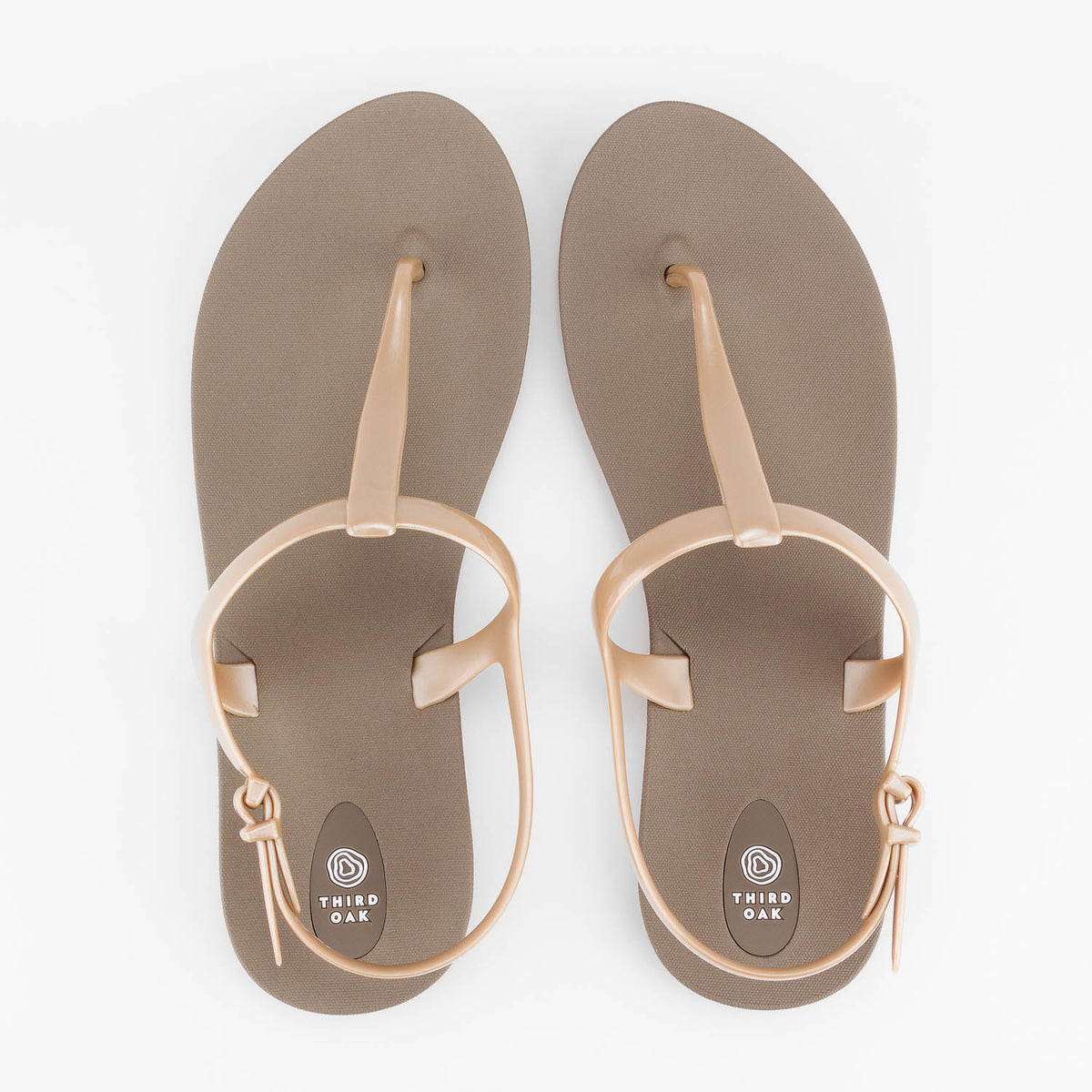 Sandals Journey designed by Third Oak metallic finish vegan cruelty free sturdy design made with bio based material 45% soy by weight 100% recyclable made in the USA eco friendly flats flip flops stylish shiny cute adjustable heel strap vacation good quality american made eco safe environmentally friendly best flats vacation open toe thongs good quality buy online clearance sale neutral color durable beige gold beach shoes dressy cute pretty elegant goes with shorts dress up or down good carry on stylish 