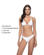 A woman from Dallas Texas is lounging on the beach looking ravishing in macrame White triangle bikini top water lily Isla tri top PQ Swim white bikini bottoms water lily basic ruched bottoms full coverage . She bought this chic white halter bikini top and low rise bikini bottoms from sun vixen swimwear, the best online retailer for designer swimsuits in USA, Canada & worldwide. She frequently shops from this top quality google store for stylish luxury bikinis, sexy swimsuits, high end beach cover ups online