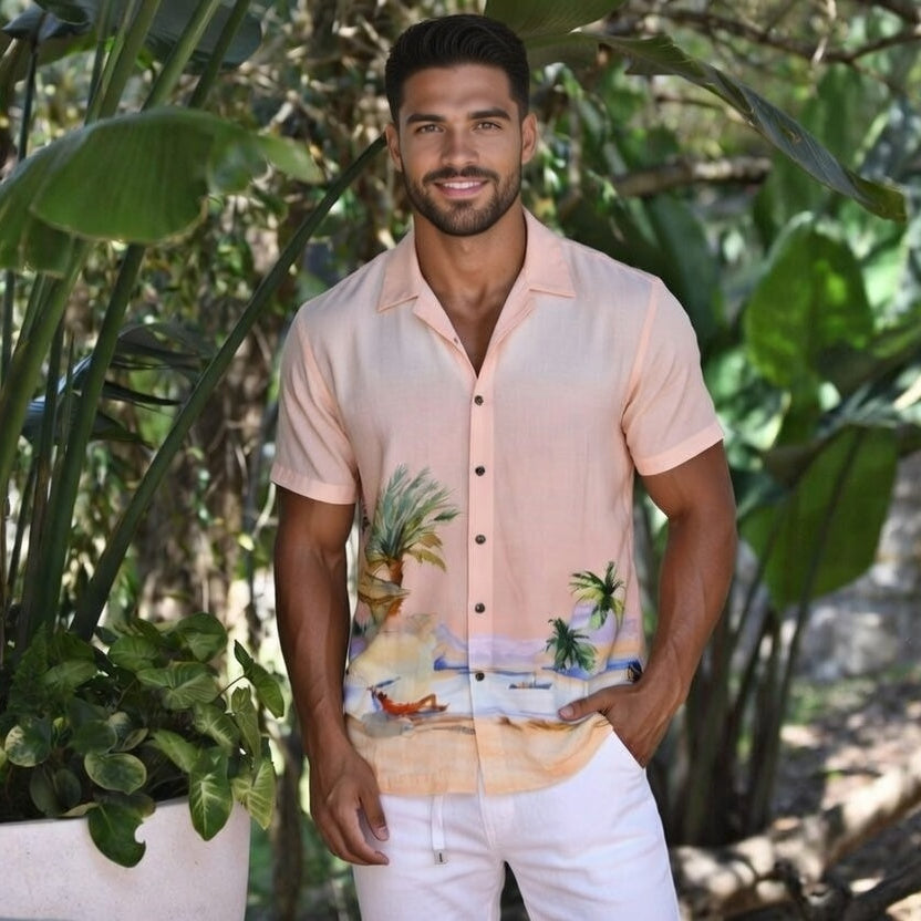 A stylish man wears a designer Hawaiian beach shirt from Sun Vixen Swimwear on a tropical vacation. This mens designer swimwear store offers the best luxury beach shirts, featuring floral beach shirts, designer mens beachwear, and premium resort shirts, perfect for a smart resort  beach look. This mens designer swimwear store features the best luxury beach shirts, cool beach shirts, sustainable mens beachwear, and tropical shirts, stylish resort shirts, and stylish resort shirts, high end designer beachwear