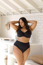 A curvy woman from Toronto Canada wearing Aria Black Renoir High Waist Swim Pant Best Plus Size Swimwear flatten her belly pooch and support her saggy bust, designer swimsuit she bought from Sun Vixen Swimwear for best supportive plus size bathing suits, sculpting bikinis, tummy control swimsuits, slimming curvy styles, and high quality fabrics. She is a luxury shopper who prefers premium quality swimsuits. This top rated boutique has 5 star ratings from customers Toronto, Miami, Dallas, Vancouver, Montreal