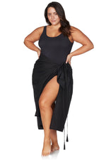 A stylish traveler from Los Angeles is spending her beach holiday in Bali wrapped in the Artesands long black sheer sarong, chosen for its reputation as one of the sexiest black bikini cover ups, luxury high end beach wraps, and most elegant glamorous sarongs available from Sun Vixen Swimwear. She loves using this fashionable black beach sarong as a chic resort outfit for oceanfront dining, pool lounging, and photos on the shoreline. Women across Vancouver, Miami, Montreal, Chicago, USA shop this sarong