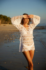 White Lace Cover Up PQ Swim Noah Tunic best quality boutique classy daring designer edgy  elegant exotic expensive exquisite bathing suits. An fashionable lady is wearing a classy sheer white beach cover up on her resort vacation to miami USA. She looks glamorous and high end wearing her good quality swimsuit that she purchased online from sun vixen swimwear the best retail swimwear store in USA & Canada for men and women who love to travel and look stylish wearing their top quality bathing suits 