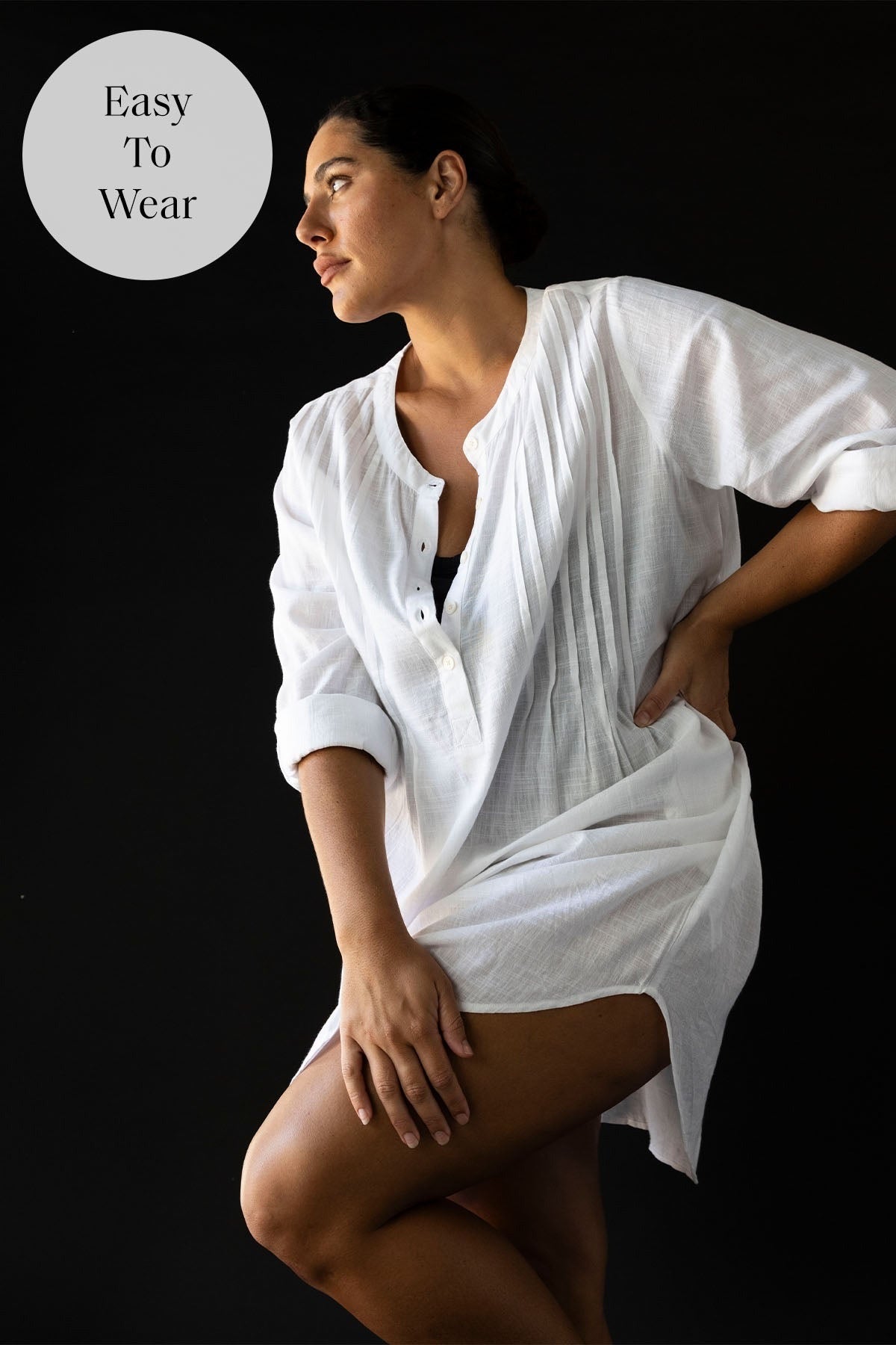 A stylish curvy woman from Montreal is spending a luxury beach vacation in Aruba wearing the white long sleeve Gershwin over shirt beach cover up by Artesands, purchased from Sun Vixen Swimwear for its reputation as one of the best luxury white cover ups, designer long sleeve beach shirts, classy bikini cover ups, high end resort wear pieces, and top quality beach vacation outfits for women across Canada and the USA. She chose this white cover up because she wanted a sexy, polished, luxury beachwear online