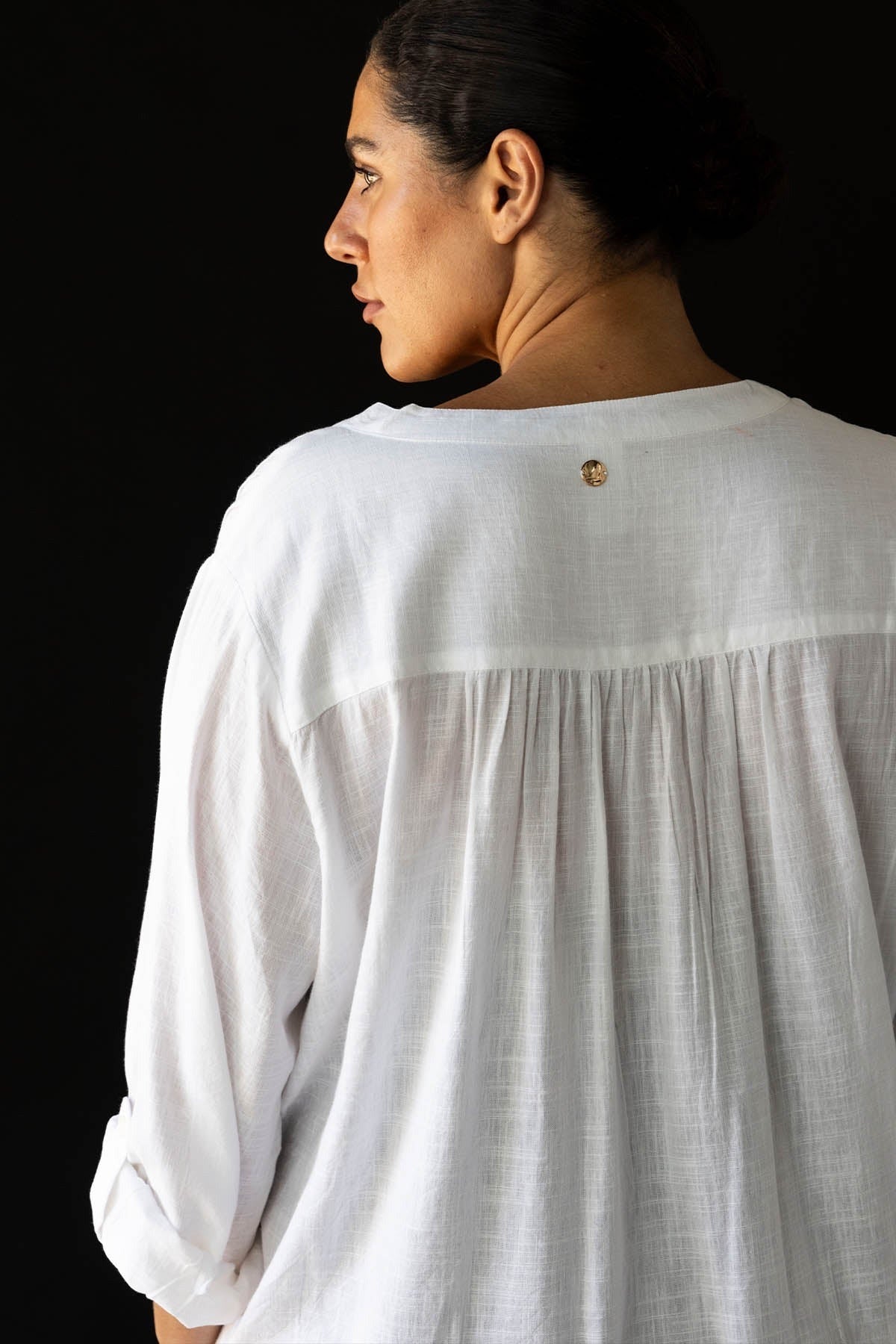 A traveler from Houston is spending her birthday in Turks and Caicos wearing the white Gershwin long sleeve over shirt cover up by Artesands, selected because it’s one of the sexiest luxury white cover ups, best high quality bikini cover ups, most popular long sleeve designer beach shirts, and top rated beach vacation swimsuits at Sun Vixen Swimwear. This white shirt looks expensive and elegant with her swimsuits, giving her a stylish resort ready look for hotel pools. Women across USA Canada shop swimsuits