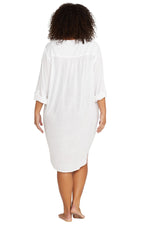 A stylish woman from Toronto is on a girls trip in Cancun wearing the white long sleeve Gershwin Artesands over shirt, known as one of the best designer white beach cover ups, luxury long sleeve swimsuit cover ups, high end resortwear shirts, and popular bikini cover ups for upscale vacations. She ordered it from Sun Vixen Swimwear to pair with her high quality swimsuits because it gives her a sexier beach outfit, luxury resort look, and lightweight cover up for tropical heat. Women across Vancouver, Dallas