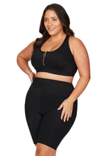 A curvy woman from Toronto is getting ready for a luxury week in Turks and Caicos wearing the Artesands Michelangelo knee length bike swim shorts, known for tummy control, compression support, sustainable designer quality, and good quality luxury swim bottoms that make every swimsuit look polished. She bought them from Sun Vixen Swimwear because they are one of the best high end womens swim shorts, perfect for beach walks, pool days,, and active resort vacations. Shop sophisticated stylish swimwer online 