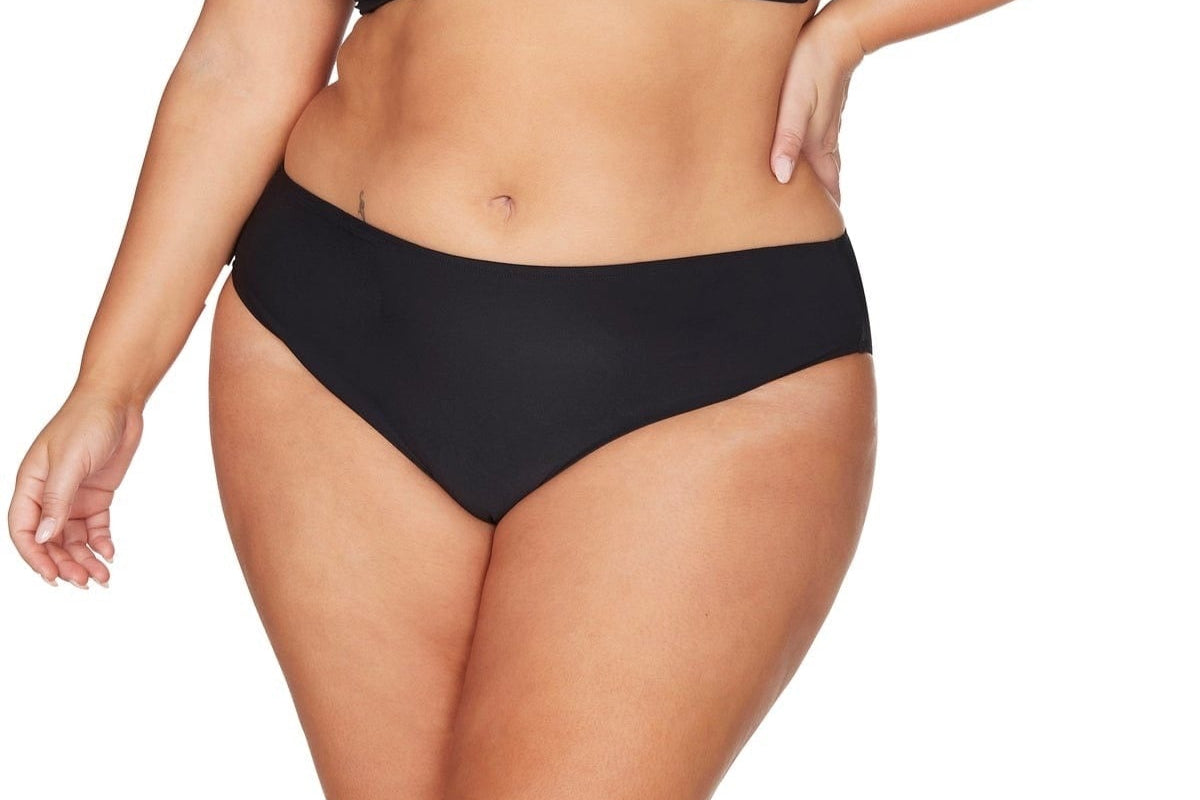 A stylish curvy woman is wearing a Mid rise tummy control bikini bottoms Artesands with tummy control tankini on a resort vacation. She bought her sexy slimming tankini top and black slimming bikini bottoms from sun vixen swimwear boutique website. Its a top rated retail store for luxury shoppers who want name brand good quality bathing suits, best plus size swimsuits for their apple shape body type, best swimsuits for large bust and big belly. Women from Honolulu, Tampa, Bakersfield, Saskatoon shop here