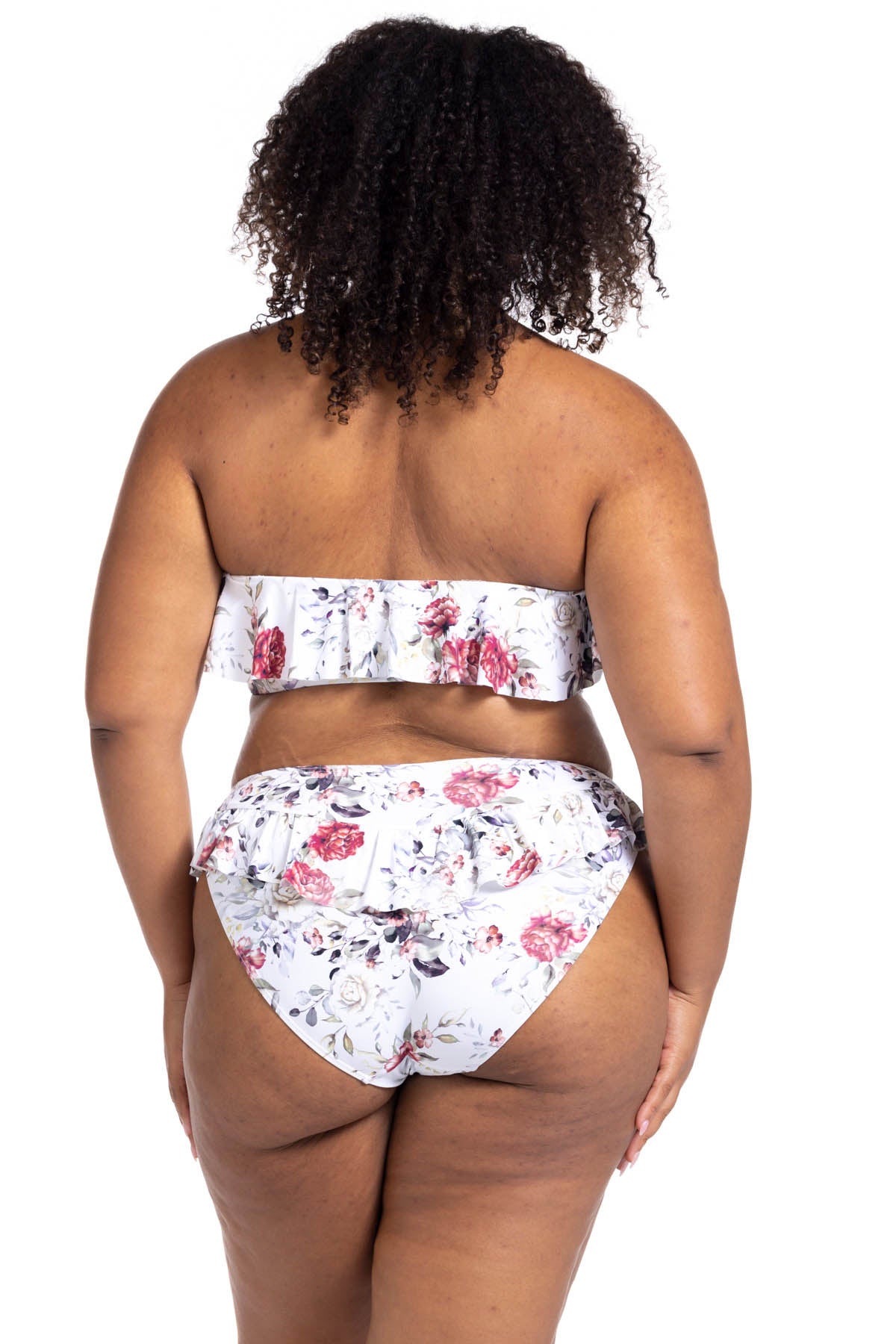 A plus size shopper from Philadelphia PA chose the Artesands Clementine White Vermeer ruffle bikini for her beach vacation, loving the cute floral swimsuit design, supportive top, and slimming high waist fit. She bought it from Sun Vixen Swimwear USA because it is the best boutique website for plus size shapewear swimsuits and tummy control bikinis for moms wanting confidence and elegance in every vacation. She feels the frilly neckline adds a sexy, feminine look. The compression bottom gives her toned look