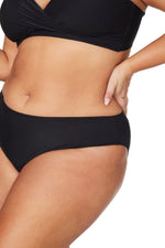 A rich plus size woman from Ottawa wearing Mid Rise Tummy Control Bikini Bottoms Artesands on high end resort vacation Palm Springs. She purchased her elegant slimming tankini top, black mid rise tummy control bikini bottoms from sun vixen swimwear boutique website. Its the best retail store for luxury shoppers who spend money on good quality bathing suits, flattering swimsuits for curvy women, best plus size bikinis. Women from Toronto, Edmonton, Bakersfield, Saskatoon shop here for womens swimsuits online
