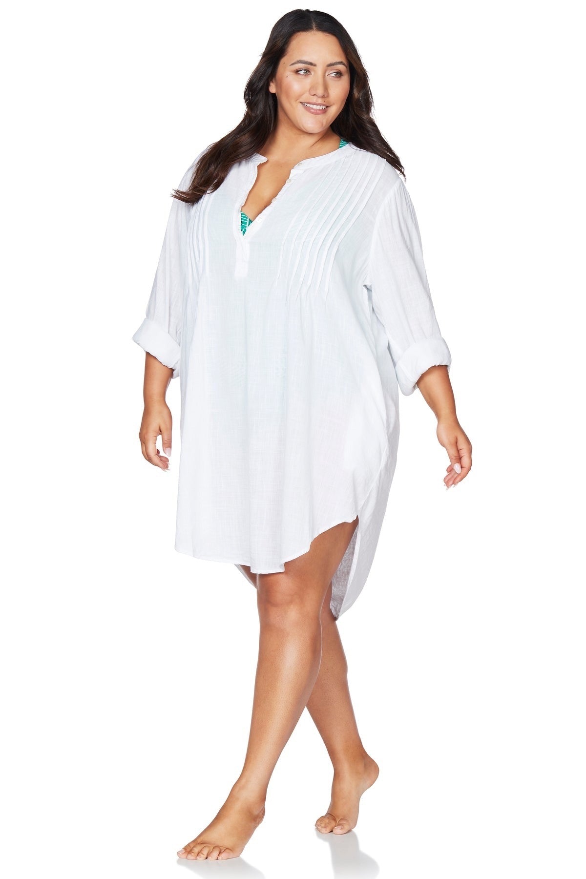 A curvy woman from Toronto is vacationing in St. Lucia wearing the white long sleeve Gershwin over shirt by Artesands, a sexy luxury cover up known for being one of the best white beachwear shirts, designer swimsuit cover ups, high quality resort fashion items, and popular high end vacation cover ups sold at Sun Vixen Swimwear. She loves this white shirt upgrades every swimsuit into a chic, classy, travel outfit for beach clubs, luxury resorts, poolside cocktails. Popular with shoppers in Vancouver, Dallas
