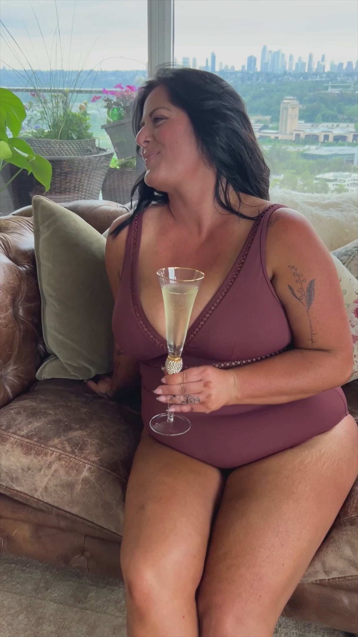 A classy woman is wearing a tummy control swimsuit for her curvy body. She came across Belly flattening best plus size bathing suit on sun vixen swimwear USA Canada that sells most flattering luxurious sexy designer swimsuits for bigger women. This lady from Toronto Canada purchased Lola Shimmer Cinnamon Cross Front Spliced Multifit One Piece rust swimsuit designed by sea level Australia known for their sculpting elegant bathing suits for moms classy tummy control designer full coverage good quality swim
