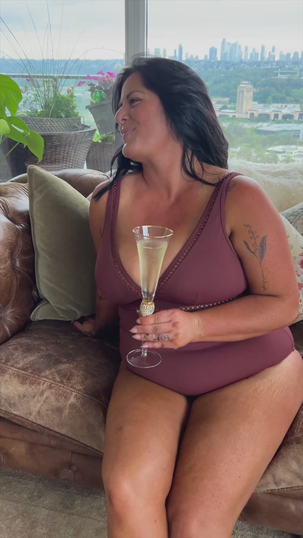 A classy woman is wearing a tummy control swimsuit for her curvy body. She came across Belly flattening best plus size bathing suit on sun vixen swimwear USA Canada that sells most flattering luxurious sexy designer swimsuits for bigger women. This lady from Toronto Canada purchased Lola Shimmer Cinnamon Cross Front Spliced Multifit One Piece rust swimsuit designed by sea level Australia known for their sculpting elegant bathing suits for moms classy tummy control designer full coverage good quality swim
