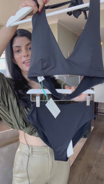 Black Halter Bikini Top Sea Level Australia Essentials D/D halter bra by sea level Australia worn by a lady from High Waisted Swimsuit Bottoms With Tummy Control Essentials retro high waist pants. She shops online for supportive swimsuits designed with slimming shape wear fabric on sun vixen swimwear Miami. Luxury shoppers in Las Vegas, Houston. Buy now classy black bikinis with shaping slimming full coverage bikini bottoms, elegant high leg swimsuits, best black bikinis USA Canada online boutique swimwear