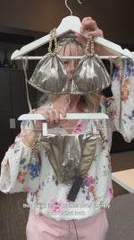 Want to look like a celebrity? Buy this high end fashion shiny metallic bikini set made with quality italian fabric finished with gold chain accents to the halterneck triangle top and sides of the full coverage bottoms. Designer bikini made in the USA by sauvage and sold online by sunvixen.com a quality swimwear retailer located in Canada selling designer swimwear to thousands of customers in the USA & Canada, italy, Australia, Belgium, France, New Zealand, Greece, Spain and many other countries worldwide. 