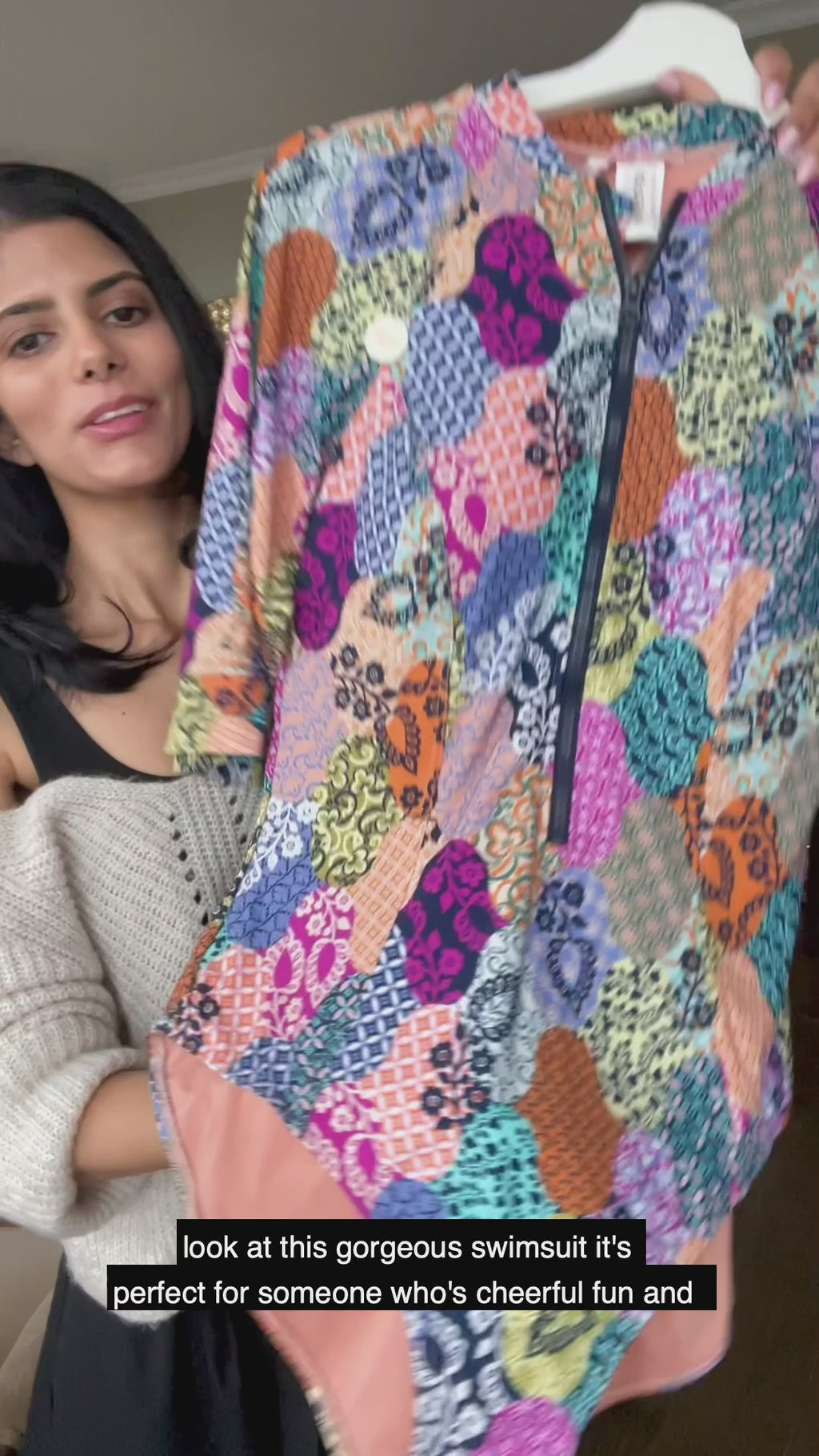 A stylish woman from Toronto Canada wears her new Artesands Salmagundi Seurat Sun Suit colorful half sleeves zippered one piece swimsuit with SPF, Artesands tummy control swimwear. She ordered it from Sun Vixen Swimwear, known for carrying the best plus size swimsuits, supportive tummy control one piece bathing suits, and luxury curvy swimwear for women who want elegant resort swimsuits. She’s packing this flattering zip front swimsuit for tropical trip to Maui that lifts her bust, and slims her belly pooch