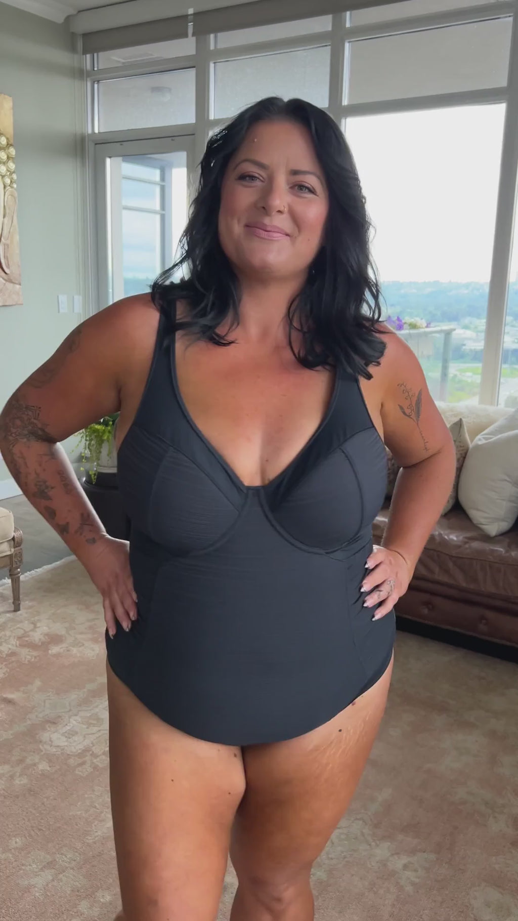 A woman from Los Angeles is celebrating her birthday in Aruba, wearing the Plus Size Aria Giotta Artesands premium tummy control underwire one piece swimsuit, a luxury bathing suit known for its high quality shaping, soft yet supportive structure, and full bust lift for sagging breasts, giving curvy women an elegant and elevated silhouette for upscale vacations. She loves how this swimsuit smooths her tummy, contours her waist, and enhances her bust, making her feel graceful elegant on beach vacation 