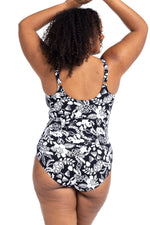 A plus size woman from New York USA wears the Artesands Cantata Forte Black Delacroix black floral tummy control one piece swimsuit for its slimming, supportive shapewear swimsuit design, luxury fabric good quality sculpting bathing suit, high end elegant plus size swimwear features. She bought it from Sun Vixen Swimwear USA Canada, known for best swimsuits for tummy control, ladies curvy luxury resort swimwear, high quality flattering designer bathing suits, premium supportive swimwear for plus size women
