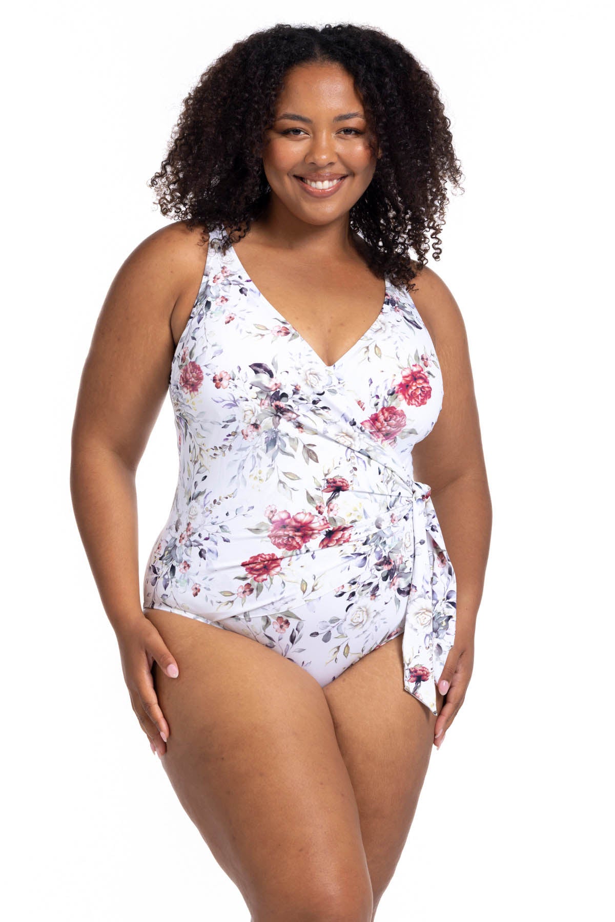 A curvy woman from Edmonton is enjoying a luxury girls trip in Cancun wearing the Clementine White Hayes plus size underwire one piece wrap swimsuit by Artesands, known for its strong supportive underwire for sagging breasts, high quality tummy control shaping panel, and premium luxury plus size swimwear construction. She loves this sexy elegant designer swimsuit because it gives her a sophisticated resort look, perfect for beach clubs, resort pools. Women from Canada USA shop online best quality swimsuits 