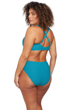 A plus size traveler from Dallas Texas bought the Rhapsody Teal Botticelli supportive underwire bikini top with tummy control high waist bikini bottoms by Artesands for her Caribbean vacation, loving how this designer swimwear lifts her bust and smooths her waist. She purchased it from Sun Vixen Swimwear because she prefers classy curvy ladies swimwear that feels luxurious and flattering for bigger women. She always shops for sexy slimming swimsuits and sophisticated designer bathing suits from this store