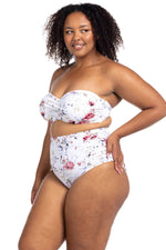 A stylish curvy woman from Toronto Canada steps onto her resort balcony in Hawaii, wearing the Artesands Clementine White Botticelli Ruched Swim Pant, luxury high waisted plus size bikini bottoms designed to slim, sculpt, and tone. She prefers swimsuits that shape her curves with tummy control, making this bikini bottoms for lavish beach holidays. She bought it from Sun Vixen Swimwear USA Canada, which offers the best supportive plus size designer swimwear. Women from Phoenix, Edmonton Vancouver shop here