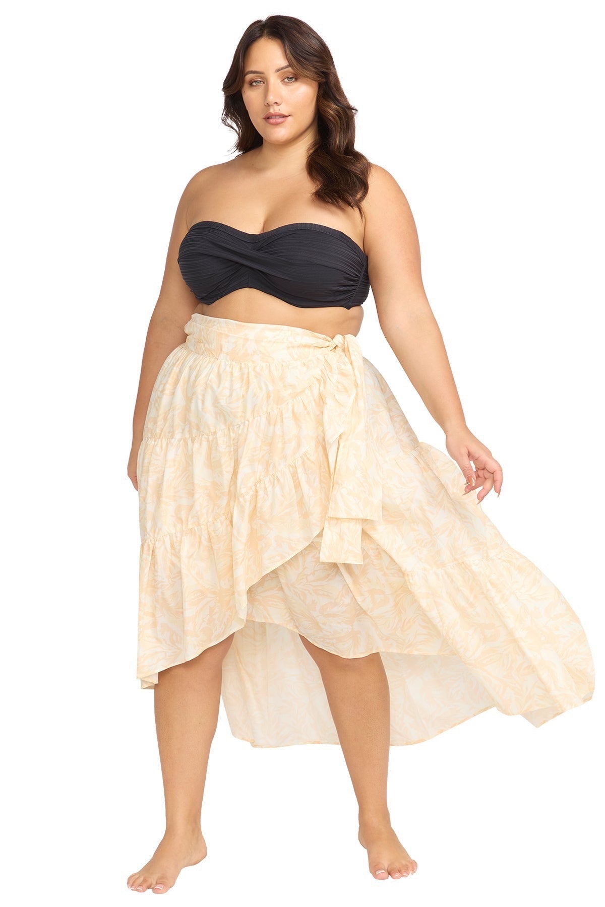 A curvy woman from Toronto is spending a luxury beach vacation in Tulum wearing the Artesands Areca Cea Elgar high low wrap maxi skirt, a boho swim wrap skirt trending as one of the sexiest plus size beach cover ups, luxury high end tie skirts, and best quality designer beachwear at Sun Vixen Swimwear. She chose this boho resort wrap skirt because it transforms her swimsuit into a stylish, glamorous, exquisite resort outfit perfect for beach clubs, oceanfront lounges, and tropical dinners in Aruba, Mykonos