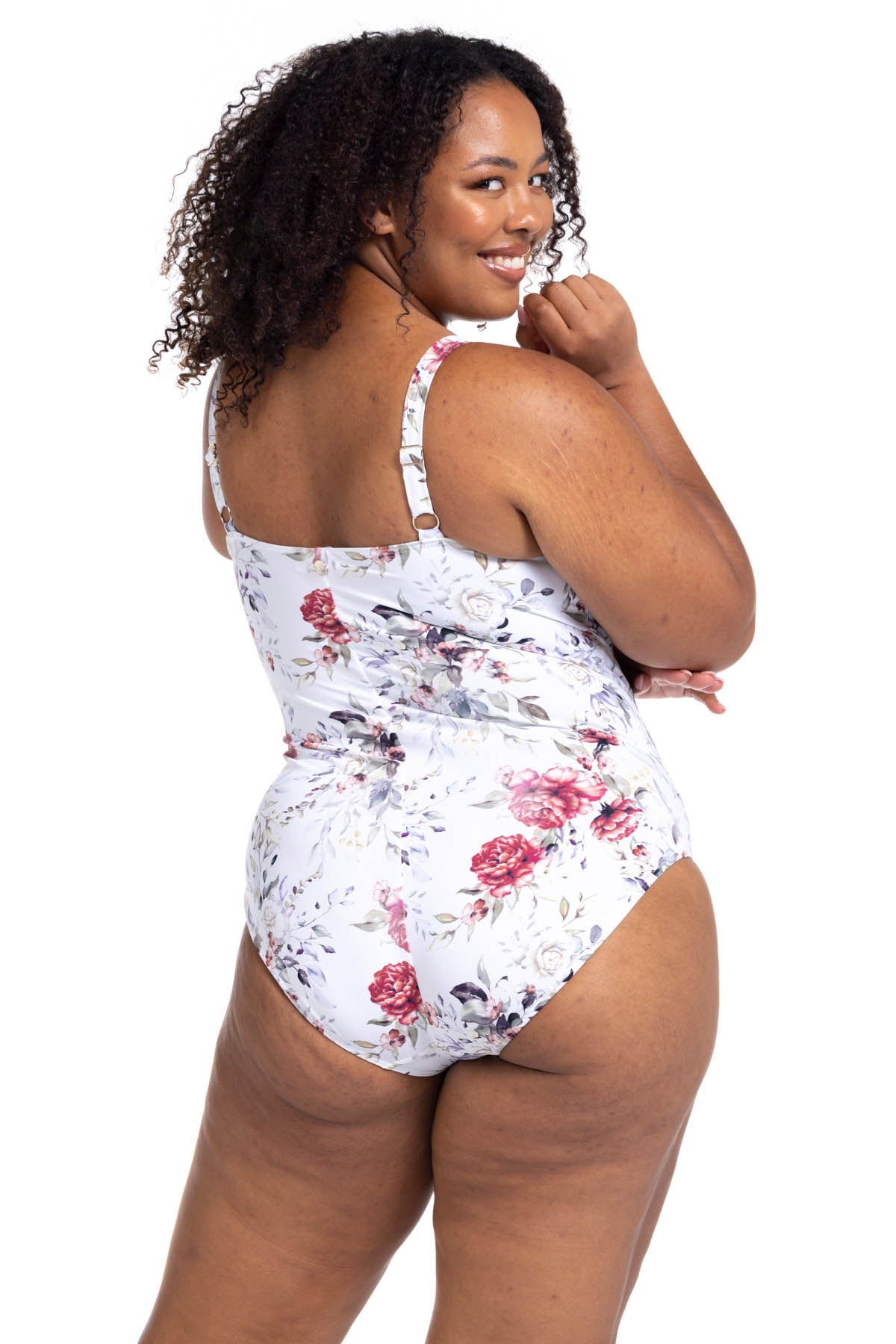 A stylish woman from San Diego is relaxing at a beachfront villa in Bora Bora wearing the Clementine White Hayes tummy control underwire one piece plus size wrap swimsuit by Artesands, a favourite among women wanting luxury supportive swimwear, lift for sagging breasts, high quality shaping design, designer resort swimwear, and premium curvy beachwear. She purchased it from Sun Vixen Swimwear because it delivers a classy sophisticated resort swimsuits for upscale tropical vacations. Women shop  USA Canada